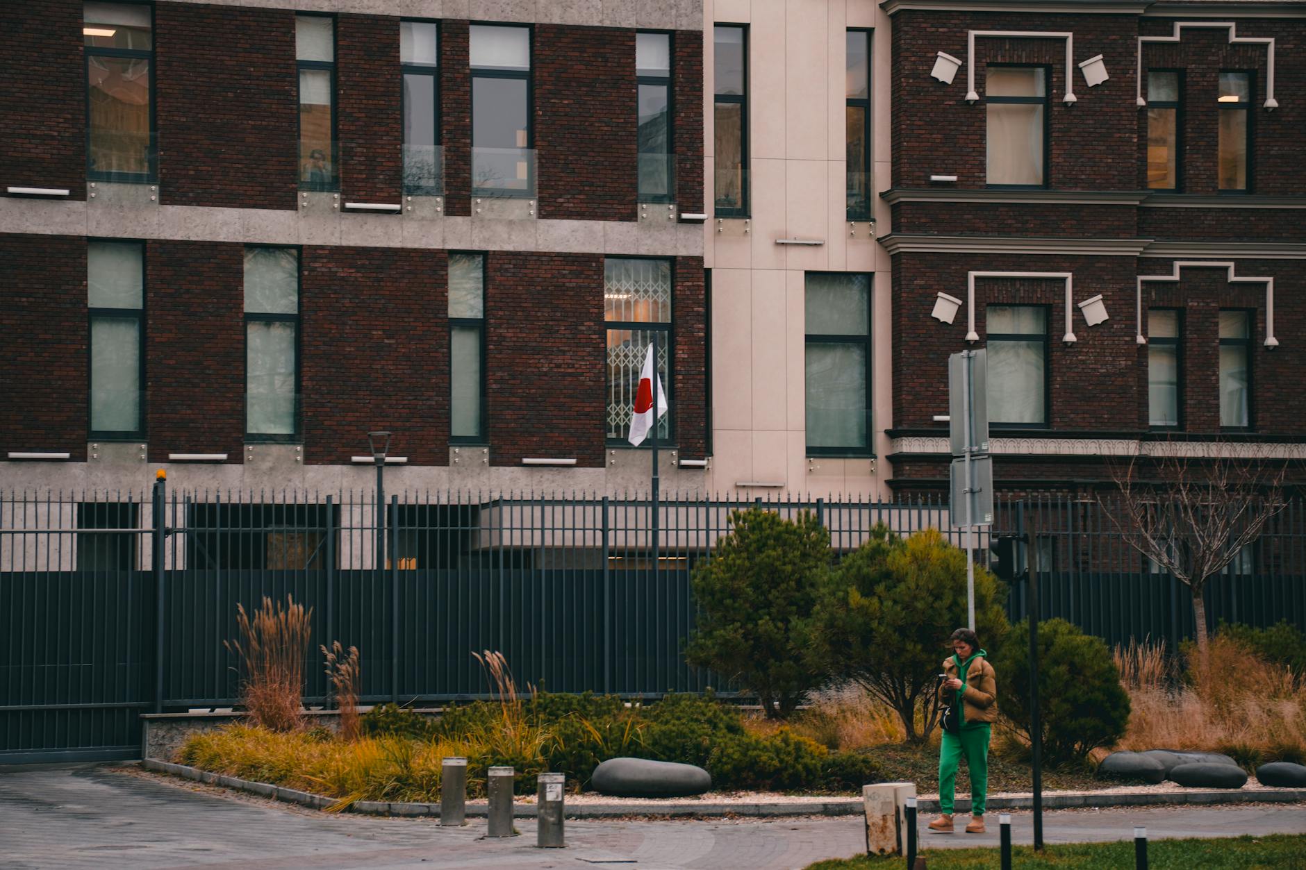 European Union flags stand outside an official building as diplomats discuss new sanctions policy.