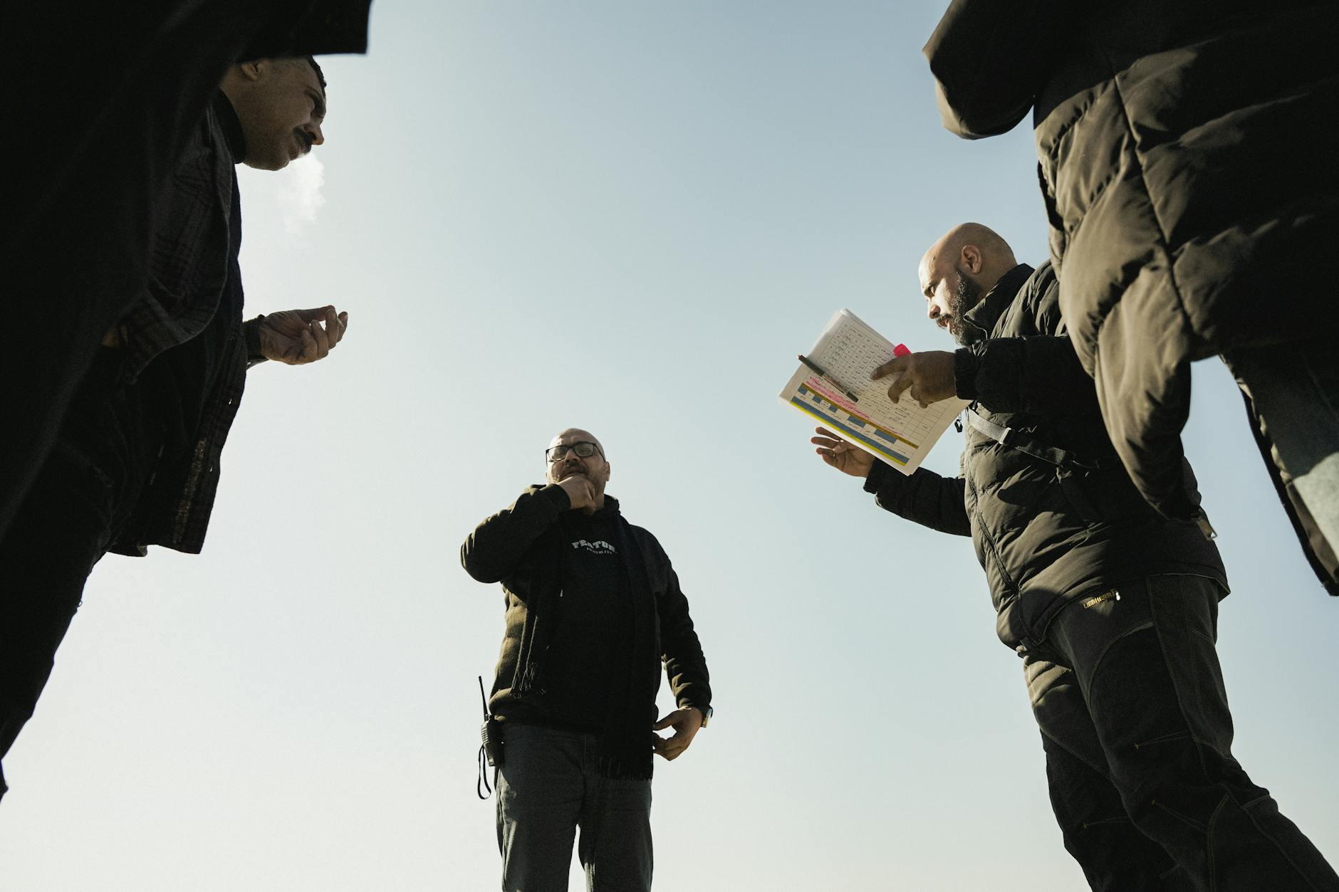European Union flags stand outside an official building as diplomats discuss new sanctions policy.