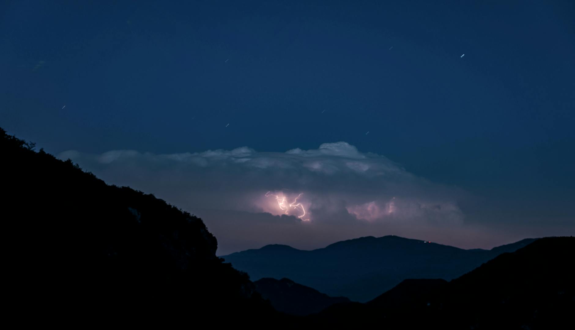 Firefighters battle flames at a damaged building in western Ukraine after a large daytime Russian drone attack that killed civilians and hit infrastructure across multiple regions.