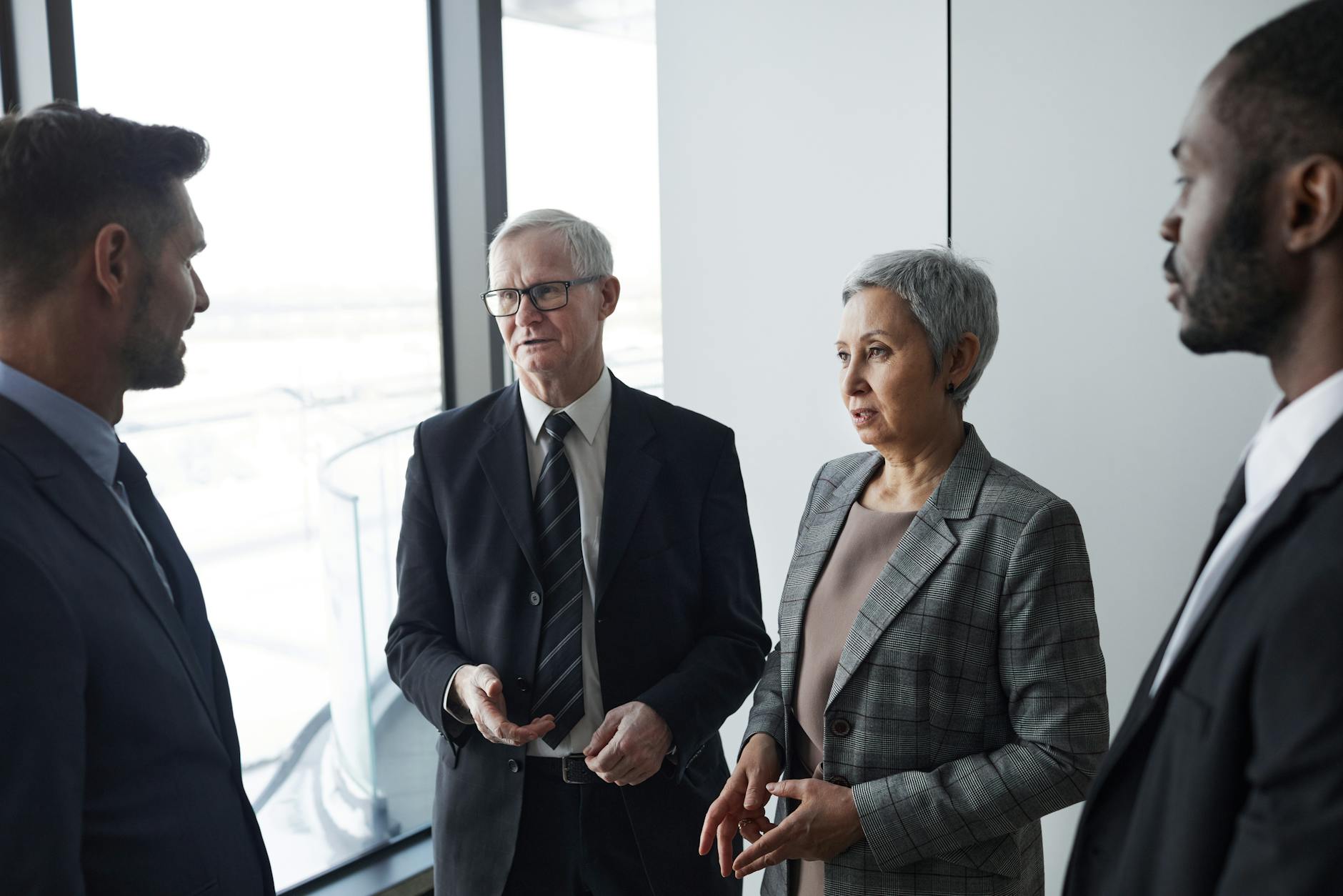 A NATO headquarters setting with officials discussing military deployment changes following US troop withdrawal plans.