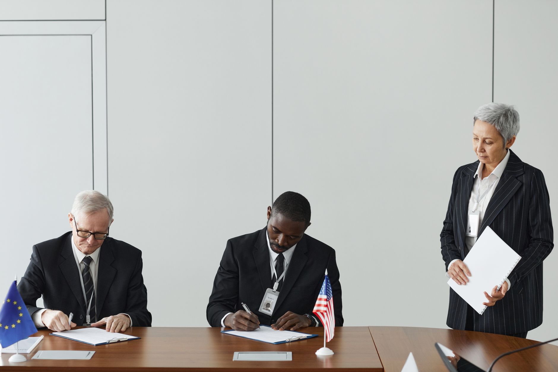 European officials discuss the EU response to US sanctions affecting the International Criminal Court in a diplomatic setting.