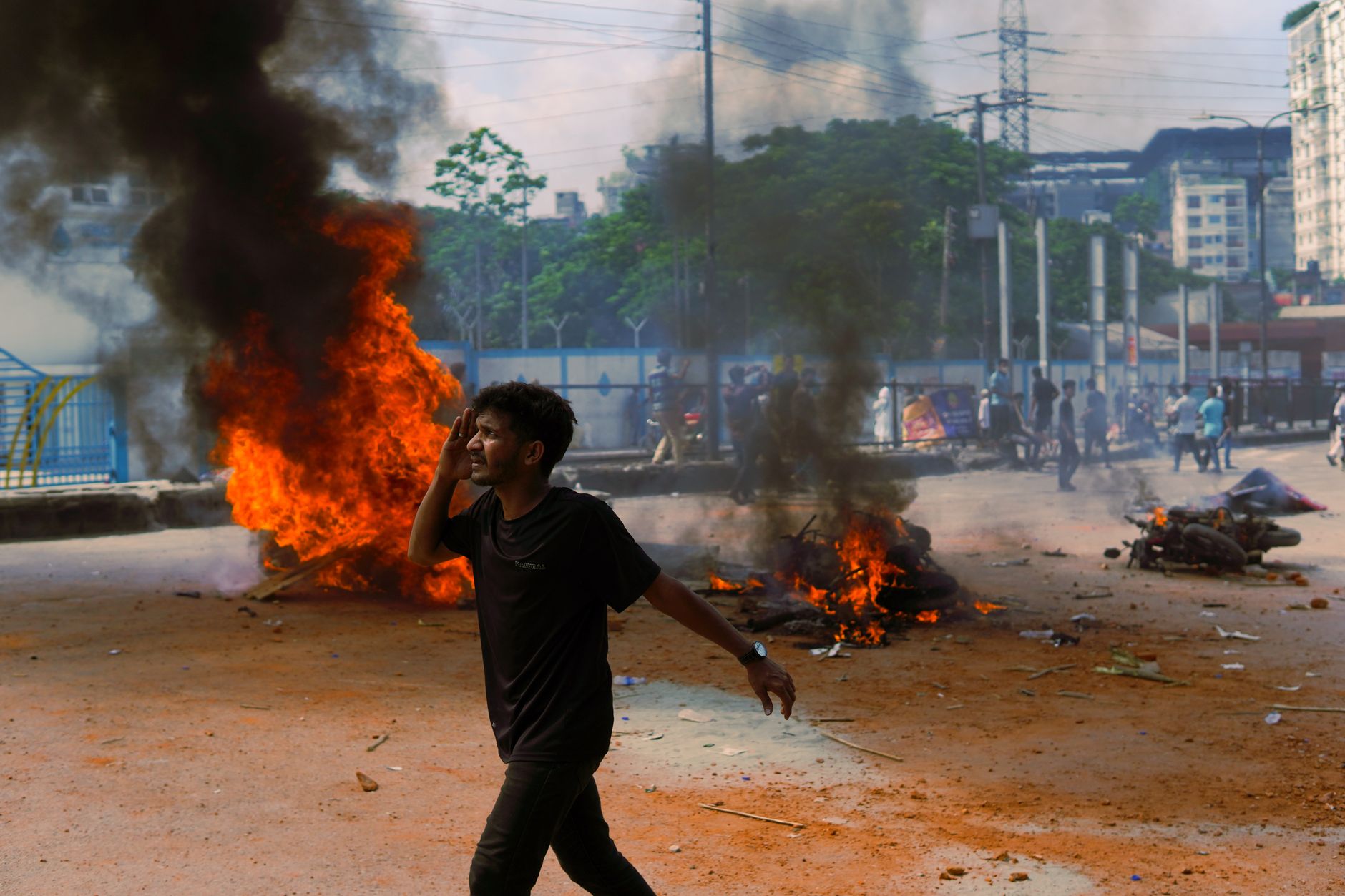 Student demonstrators confront riot police amid smoke and damaged street barriers during anti-government protests in Tirana, Albania, on October 15, 2026.